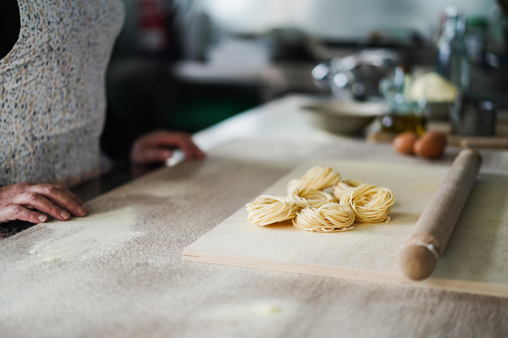 Local chef preparing fresh pasta at a wooden table
