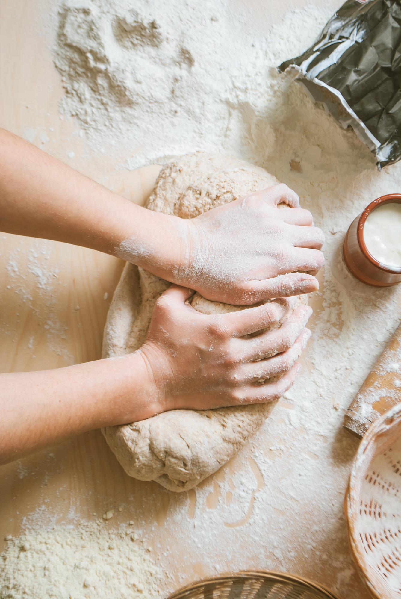 Close up of hands kneading dough